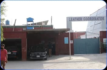 Leather Coordinator facility entrance with gate and signage