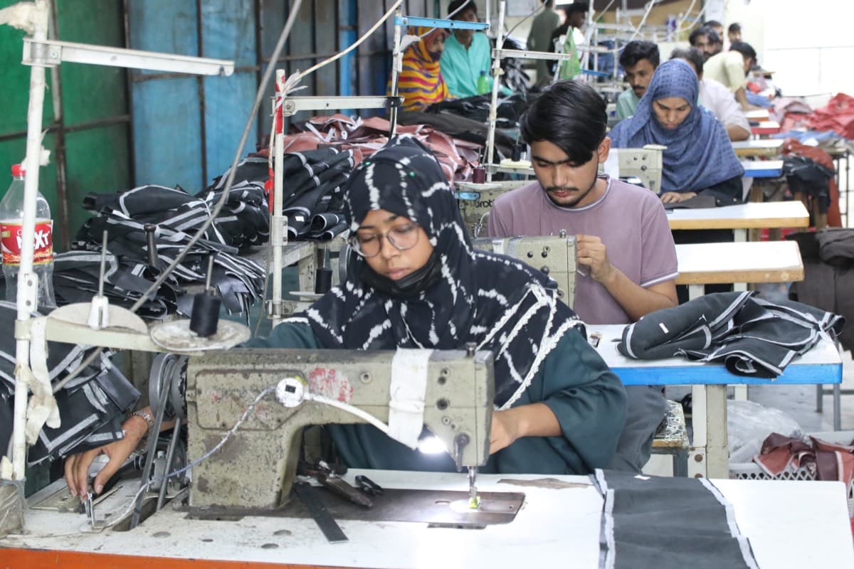 Workers operating sewing machines in a garment factory