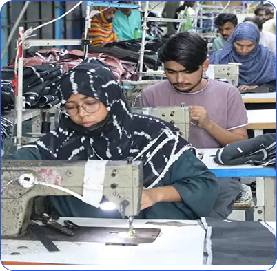 Workers operating sewing machines in a garment factory