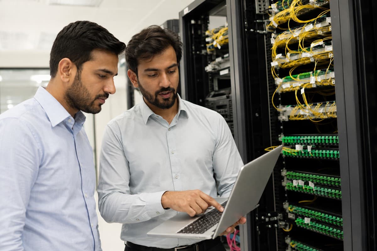 IT professionals reviewing systems in a server room