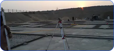 Surveying equipment on a construction site at dusk